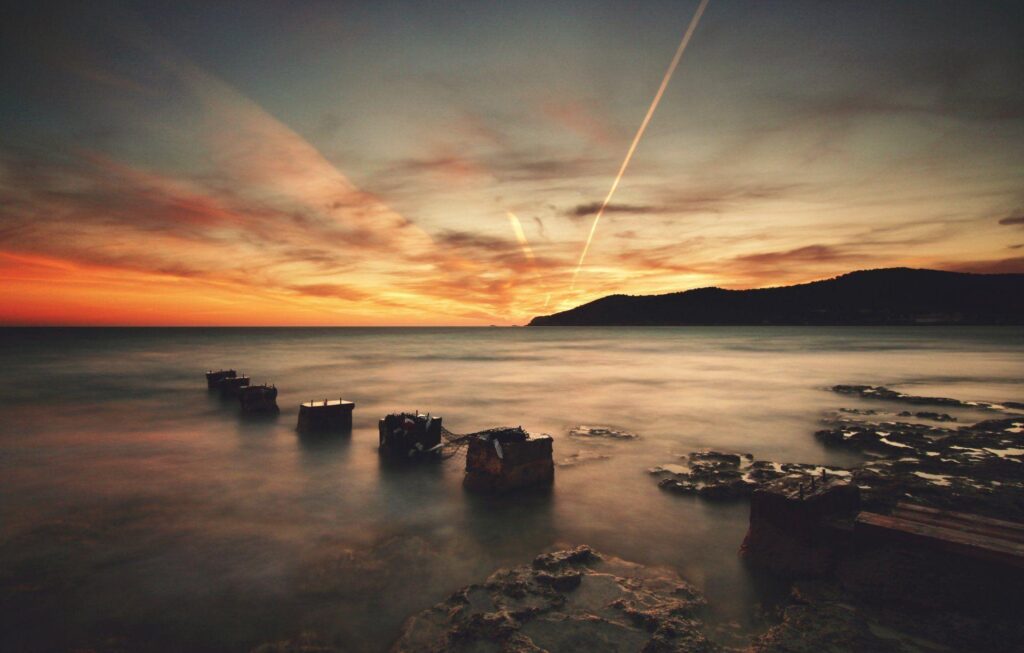 Ibiza beach water stones night rays 2K wallpapers