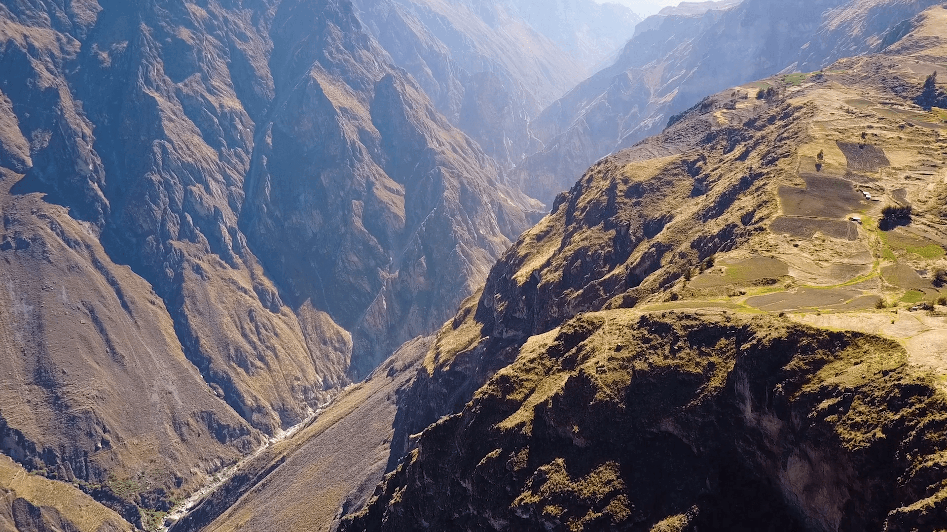 Drone aerial flying sideways over the massive Colca Canyon valley in