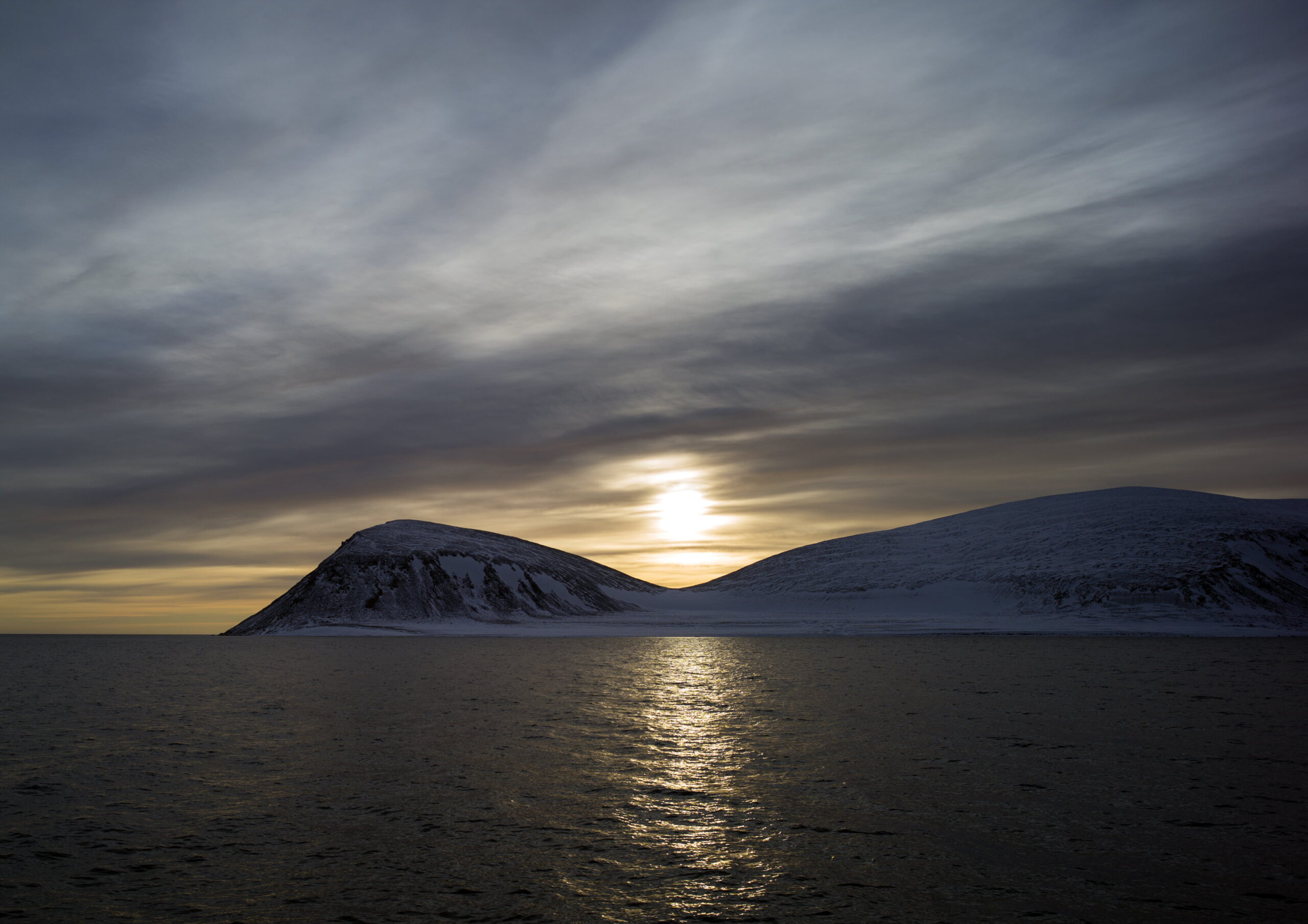 Photo of sunset under mountains, svalbard 2K wallpapers