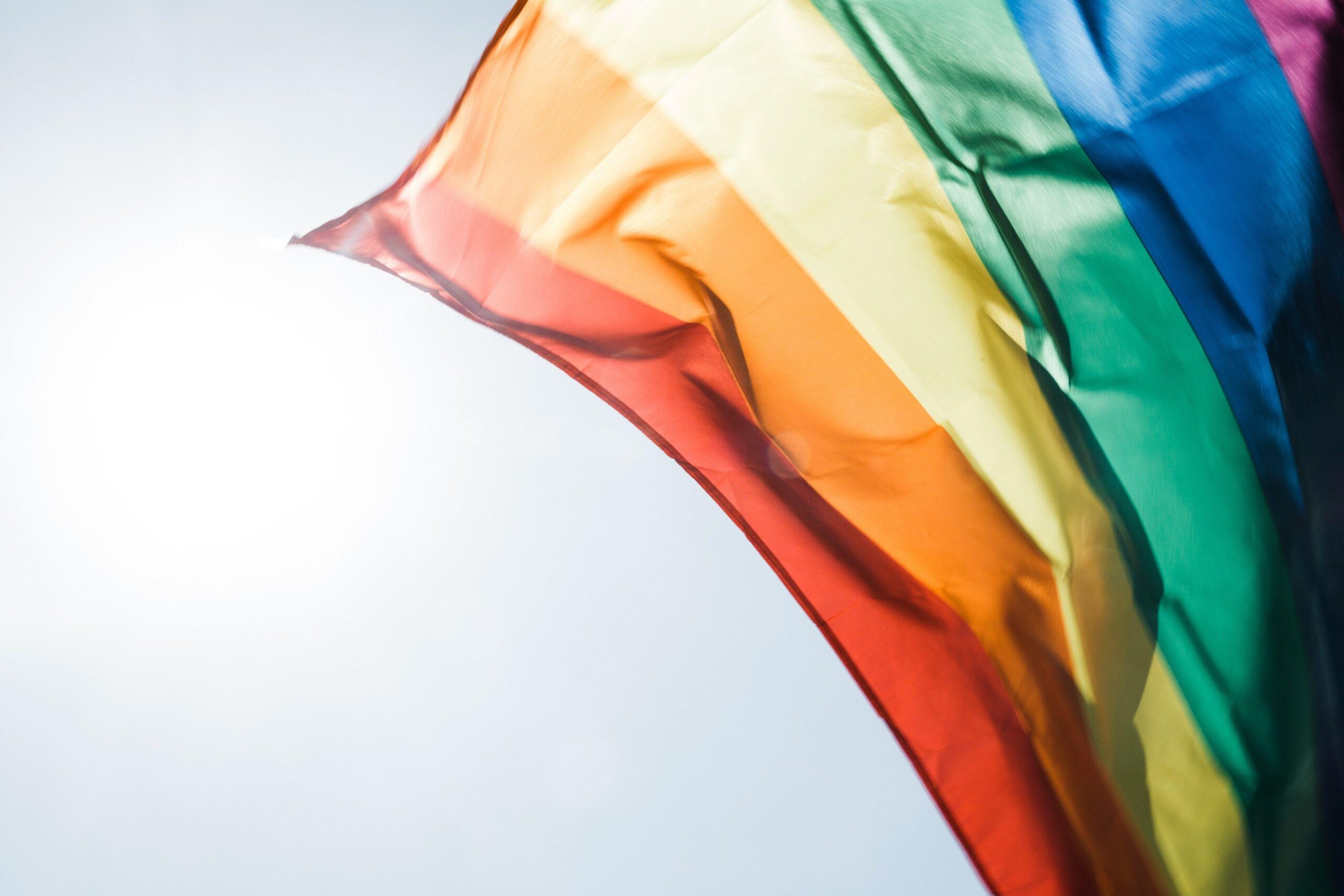 Rainbow pride flag flying in the daytime breezeproud rainbow flag k
