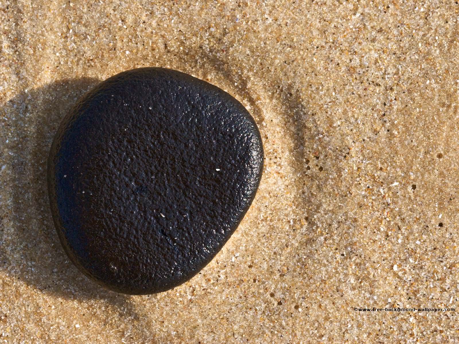 Black Pebble on a Beach Beach Backgrounds Wallpapers