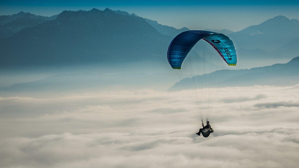 Hang Gliding above the Clouds 2K Wallpapers