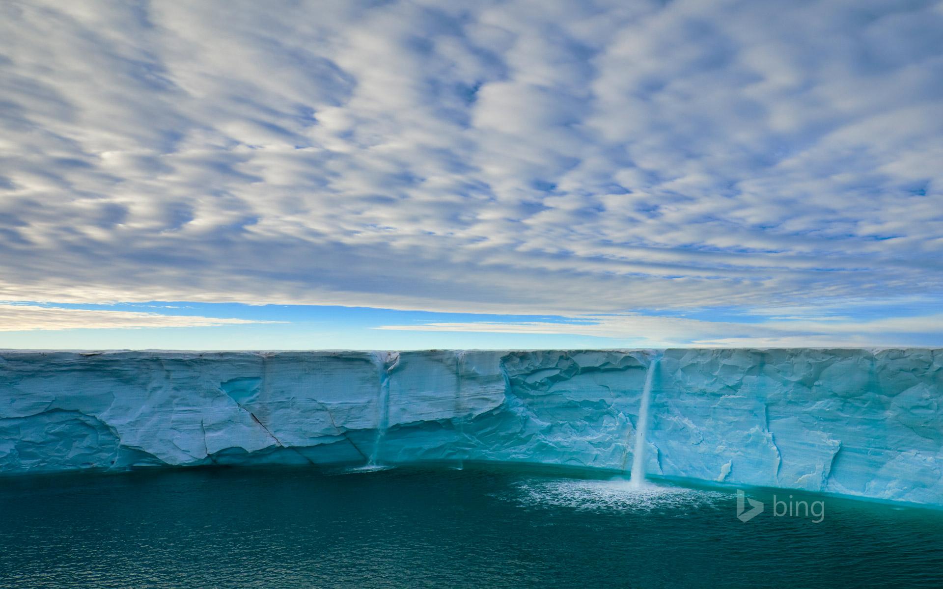 Meltwater creates waterfalls on an ice cap, Svalbard Archipelago