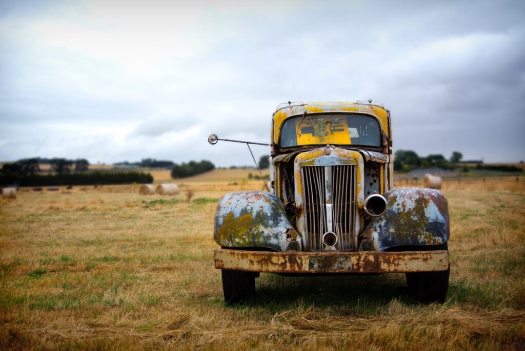 A rusted vintage yellow truck on the great ocean roadrusted truck