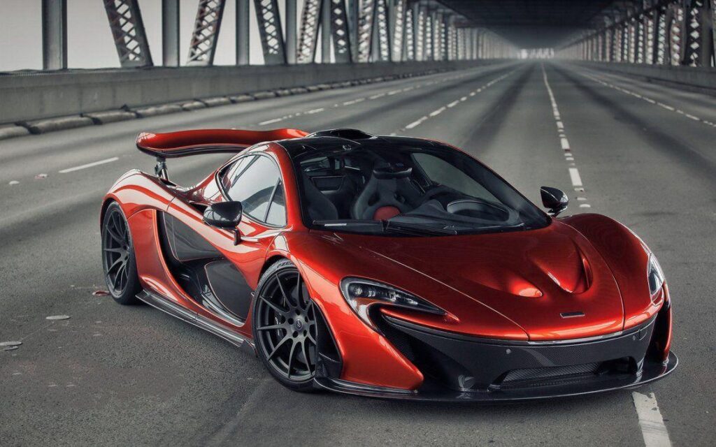 Red McLaren P on a bridge