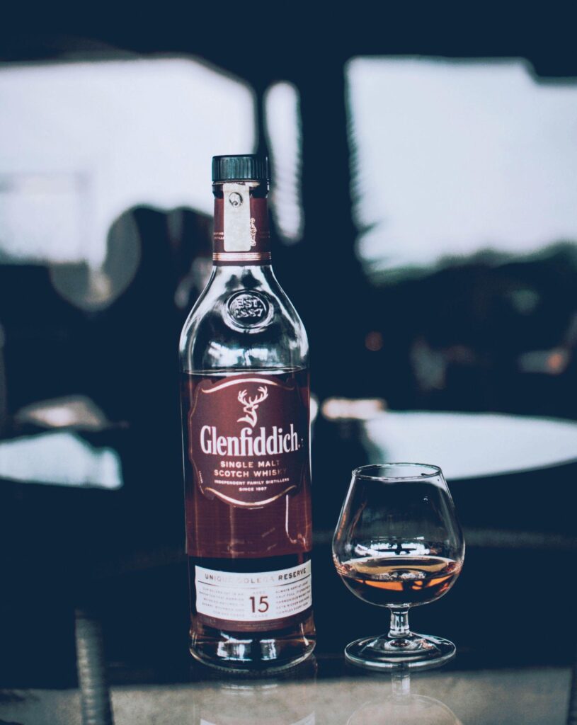 Glenfiddich Bottle Beside Wine Glass · Free Stock Photo