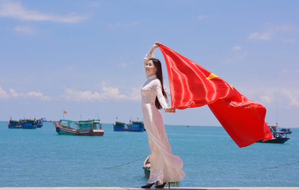 Wallpapers girl, face, the wind, star, dress, flag, Vietnam Wallpaper