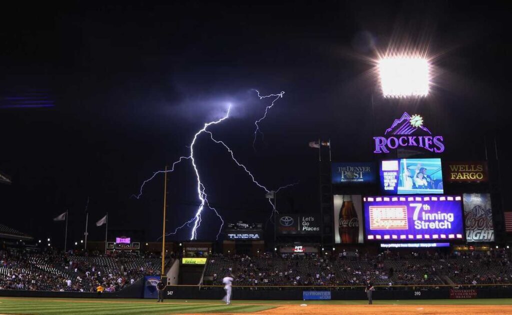 Stormy skies fill big baseball venues Rockies, Reds, and Red Sox