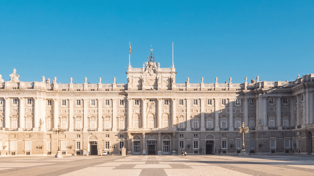 Royal palace of madrid timelapse zoom out blue sky sun lighting the
