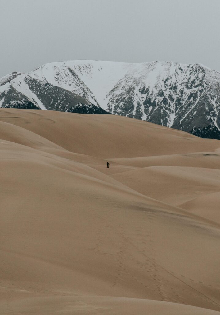 HD Wallpaper The silhouette of a lone hiker among sand dunes with