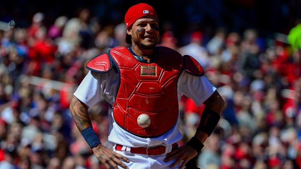 Catcher Yadier Molina can’t find the ball because it’s stuck to
