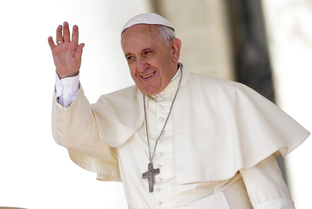 Pope Francis waves as he leads his weekly audience in Saint Peter’s
