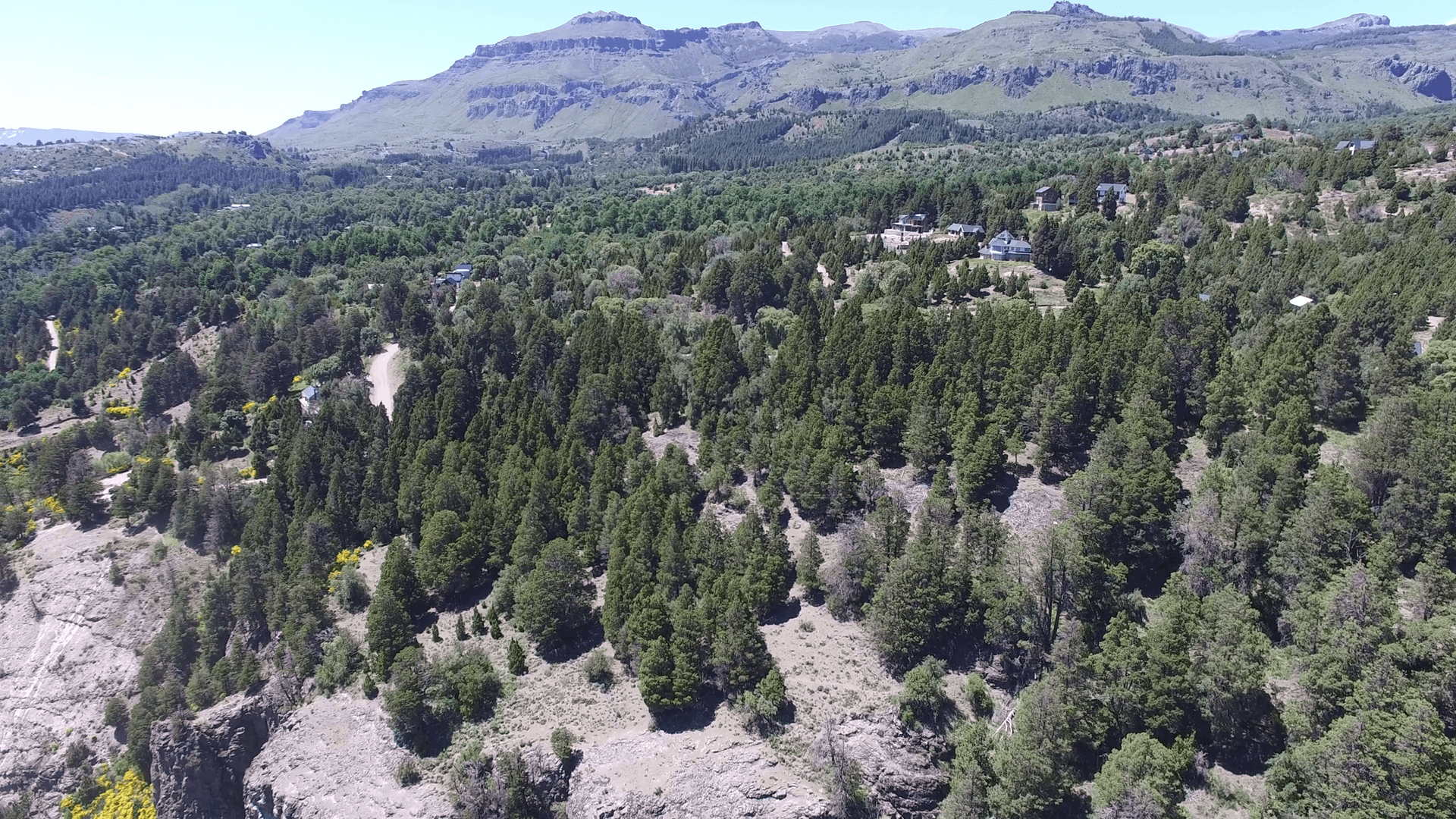 Aerial drone scene of houses in the woods in mountain in south